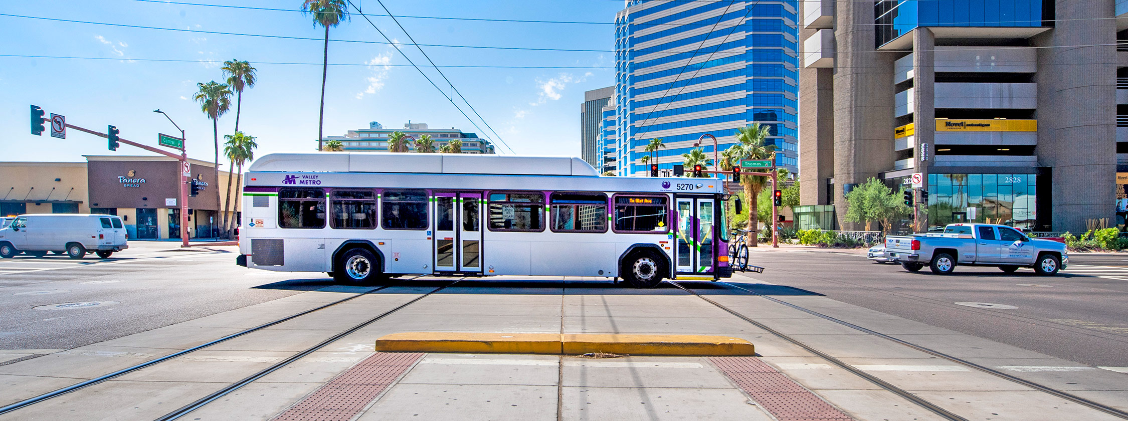 A BRT-style bus travelling down a street in downtown Phoenix